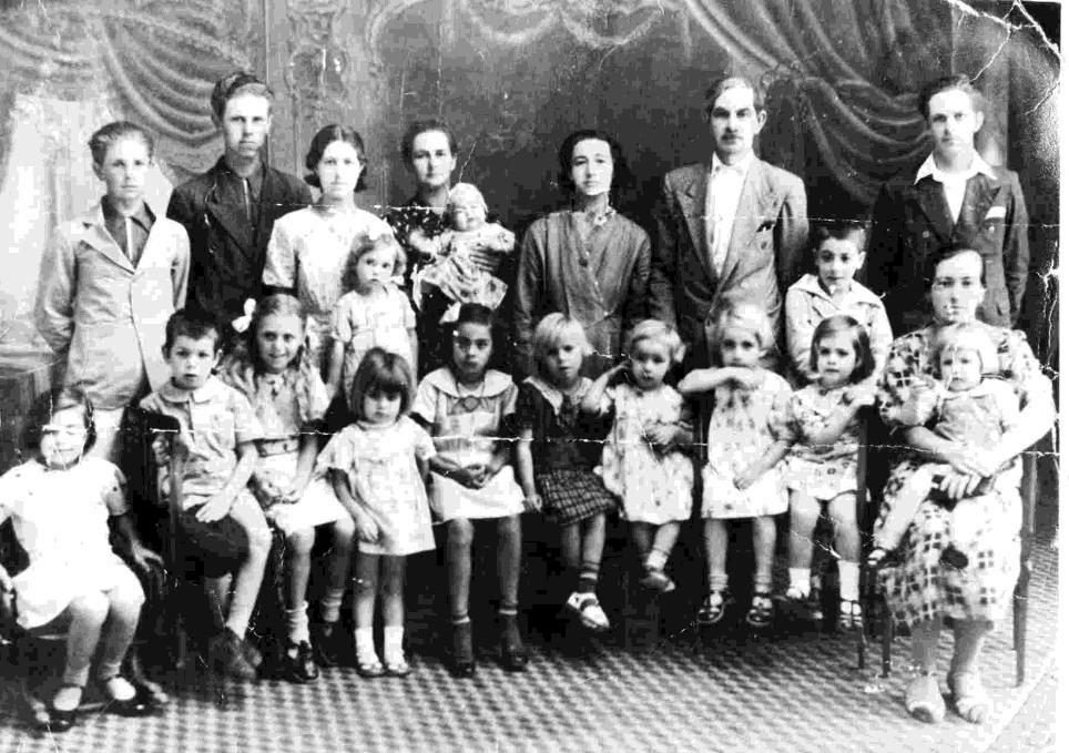 Retrato de numeroso grupo familiar de imigrantes ao ar livre